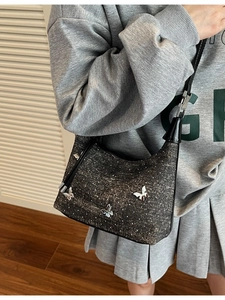 Chic dark gray denim crescent bag with silver butterfly charms and white polka dots for women