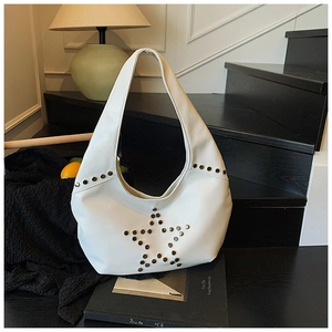 Close-up of a white punk hobo bag featuring a silver star rivet design on a dark background