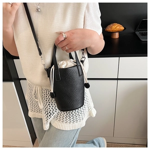 Chic black bucket bag with pebble leather texture and drawstring fabric liner detail