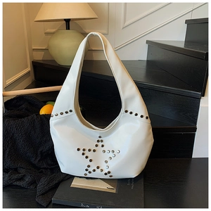Detail shot of silver star studs on white leather punk style shoulder bag