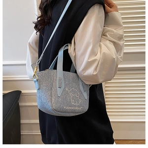 Detail of light blue glitter crossbody bag featuring cute puppy and letter embroidery