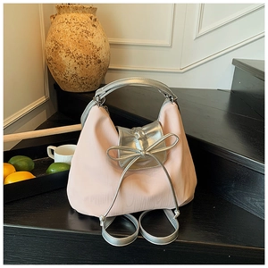 Detail of light pink tote bag with metallic silver bow and multifunctional straps