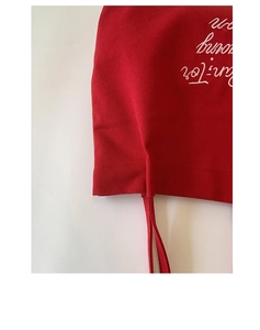 Detailed macro view of high-quality red canvas fabric and white embroidered lettering