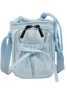 Minimalist light blue crossbody bucket bag with bow detail and adjustable wide strap