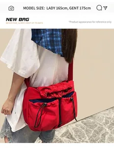 Detail of red waterproof nylon crossbody bag with dual drawstring pockets and sporty utility style