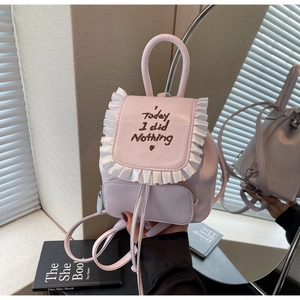 Pink mini backpack detail with satin ruffle trim and heart embroidery for daily use