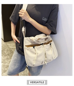 Detailed view of cream-white drawstring crossbody bag with multi-pocket nylon structure