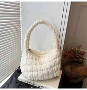 Detailed view of white quilted puffer cloud bag with soft textured fabric finish