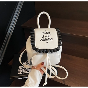 Detailed view of white mini backpack with black ruffle trim and 'Today I did Nothing' text