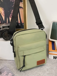 Minimalist light green canvas crossbody bag for women with adjustable strap and logo detail