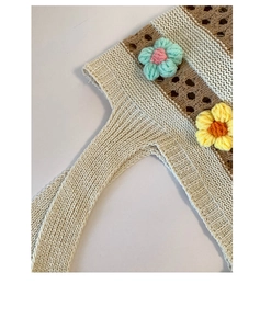 Detail shot of striped cotton knit tote featuring 3D crochet flowers and openwork texture