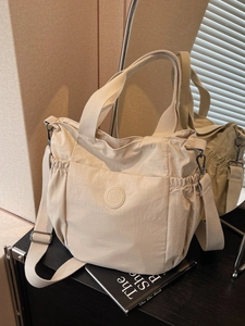 Minimalist beige nylon tote bag with large capacity and adjustable crossbody strap