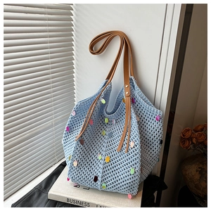 Detail of light blue crochet tote bag with colorful sequins and brown faux leather strap