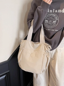Minimalist beige canvas tote bag with side pockets and large capacity for women