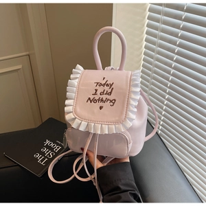 Pink mini backpack detail featuring white ruffle trim and Today I did Nothing embroidery