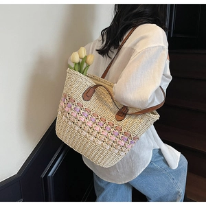 Vue détaillée du sac cabas en paille avec accents violets et anses en cuir marron