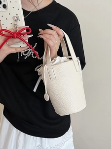 Chic off-white bucket bag with lychee grain texture and practical drawstring liner