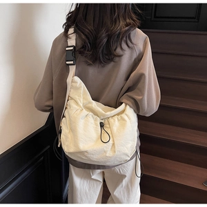 Detailed back view of a beige large-capacity crossbody dumpling bag with wide strap