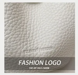 Close-up of white lychee-patterned leather texture with embossed fashion brand logo
