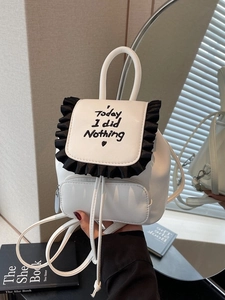 Minimalist white leather backpack with ruffled trim and Today I did Nothing embroidery