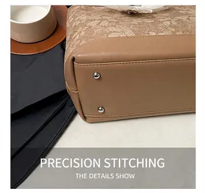 Close-up of brown tote bag bottom showing precision stitching and silver protective rivets