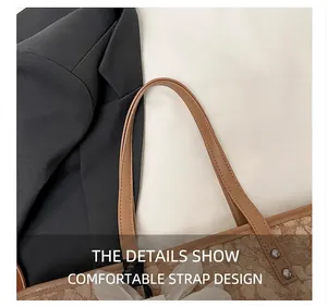 Close-up of brown tote bag with leather strap, silver rivets and floral charm detail