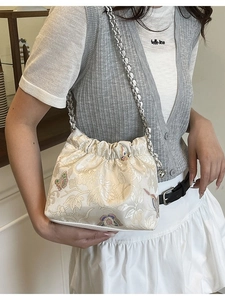 Embossed floral canvas shoulder bag with butterfly patterns and silver chain strap