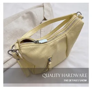 Close-up of high-quality silver metal zipper on yellow crocodile embossed leather tote bag