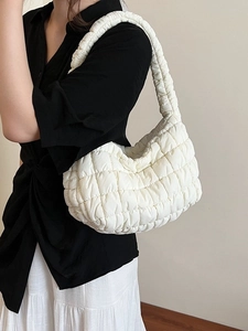 White quilted bubble shoulder bag with elegant pleated texture and minimalist puffed design