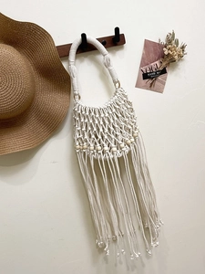 Handmade bohemian crochet tote bag with wooden beads and long tassels in white