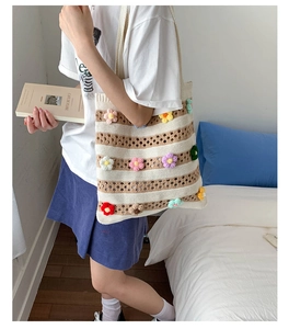 Detailed close-up of handmade crochet tote bag with colorful 3D floral accents