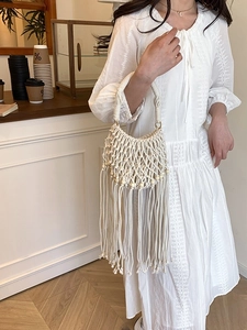 Bohemian ivory hand-woven rope bag with stylish wooden beads and long fringe tassels