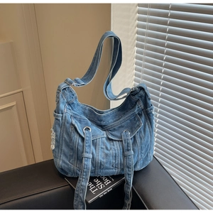 Detail view of retro blue denim crossbody bag with multiple pockets and Y2K aesthetic
