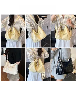 Multi-way large tote bag in yellow, white, and black shiny faux leather with tassels