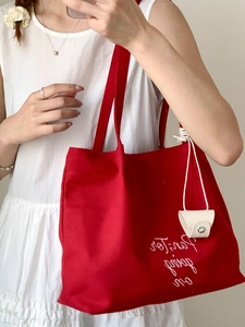 Large red canvas tote bag with white letter embroidery and leather charm for women