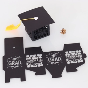 Graduation cap gift box with yellow tassel featuring hollowed GRAD and CONGRATS lettering