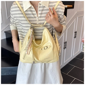 Close-up of yellow crocodile embossed PU tote with metal buckle and braided rope charm
