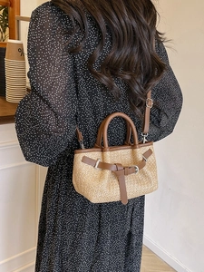 Minimalist straw woven crossbody beach bag with brown leather trim for summer vacations