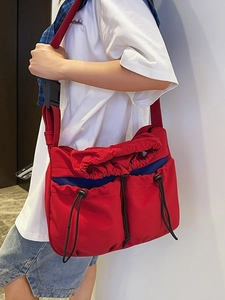 Red pleated nylon crossbody bag with blue drawstring pockets for casual daily commute