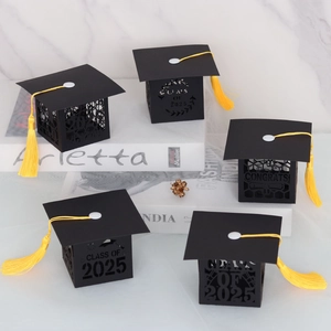 Detailed laser-cut black graduation cap candy boxes with 2025 motifs and yellow tassels