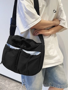 Black pleated nylon messenger bag with multi-pocket design and adjustable strap