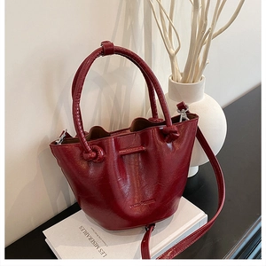 Macro detail of wine red leather handbag with VILIANS FASHION embossing and silver hardware