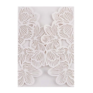 Detail of laser-cut white floral invitation card with intricate hollowed patterns