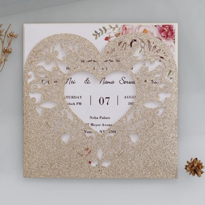 Close-up of glitter gold laser cut wedding invitation with floral inner card detail