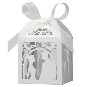 Detailed laser-cut white wedding favor box with bride and groom silhouette and ribbon