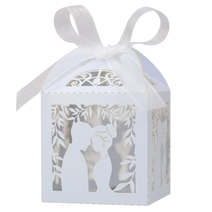 Detailed laser-cut wedding favor box featuring romantic couple silhouette and white ribbon