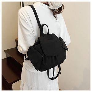 Detail of black nylon drawstring backpack with side pockets on female model on stairs