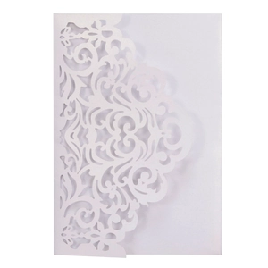 Detail showing white laser-cut hollowed European floral pattern on a wedding invitation