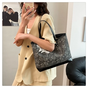 Mirror selfie showing the large tote bag size on model for daily commuting style
