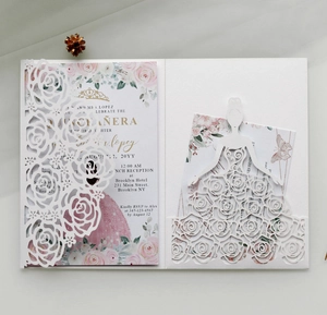 Detail of laser-cut rose and ballerina silhouette on white pearlescent invitation card